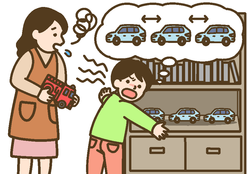 消防車を片付けようとする母親と、乗用車だけを等間隔に並べるから別の場所にしまってほしいと伝える男児